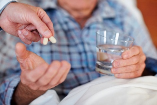 Elderly Man Taking Pills